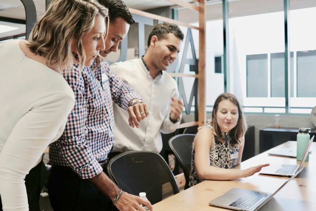 a team standing and looking at a deck of reports.